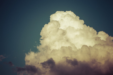 Blue sky with white clouds like a mountain. Toned.の写真素材
