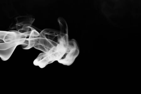 Cloud of smoke on black background. Selective focus.の写真素材
