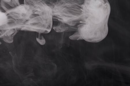 Cloud of smoke on black background. Selective focus.の写真素材