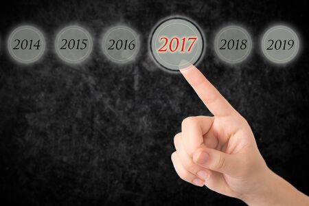 Hand of a young girl points to a figures 2017.