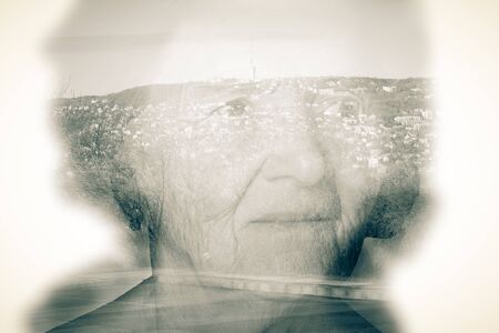 Landscape shines through the portrait of an elderly woman. Toned.の写真素材