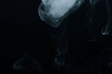 Cloud of smoke on black background. Selective focus. Toned.の写真素材