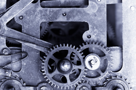 Old clockwork dirty with dust and lubricating oil. Selective focus. Shallow depth of field. Toned.の写真素材