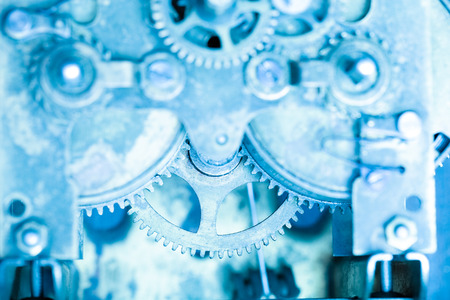 Old clockwork dirty with dust and lubricating oil. Selective focus. Shallow depth of field. Toned.の写真素材