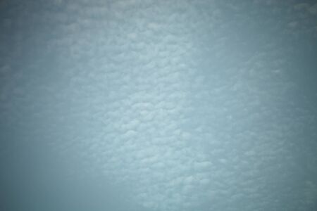 White clouds on a blue sky. Selective focus. Toned.