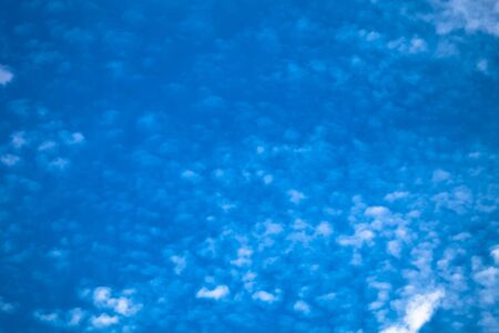 White clouds on a blue sky. Selective focus. Toned.
