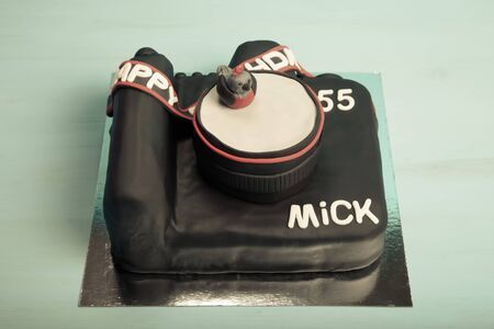 Cake with mastic on blue background. Toned.