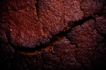 Top of fresh chocolate cake with cracks. Toned.