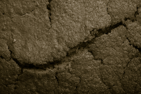 Top of fresh chocolate cake with cracks. Toned.