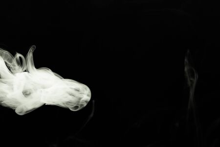 Cloud of smoke on black background. Selective focus. Toned.の写真素材