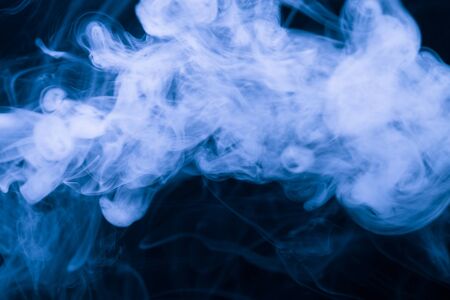 Cloud of smoke on black background. Selective focus. Toned.の写真素材