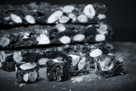 Traditional italian christmas dessert Panforte on dark background. Selective focus. Shallow depth of field. Toned.の写真素材