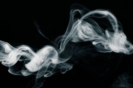 Cloud of smoke on black background. Selective focus. Toned.の写真素材