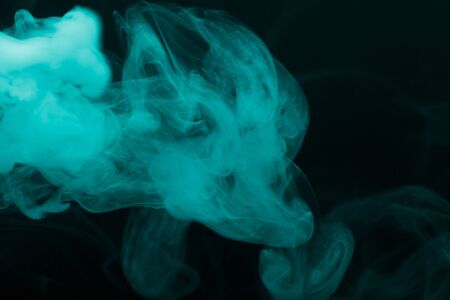 Cloud of smoke on black background. Selective focus. Toned.の写真素材