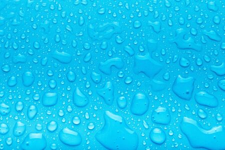 Drops of water on a color background. Blue. Shallow depth of field. Selective focus. Toned.