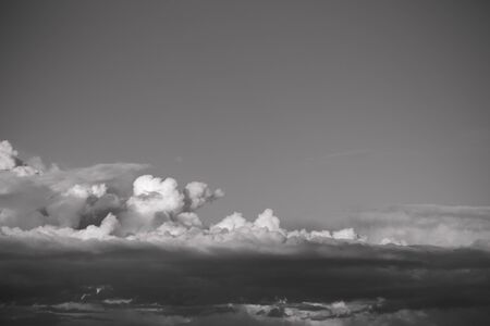 Blue sky with white cumulus clouds. Toned.の写真素材