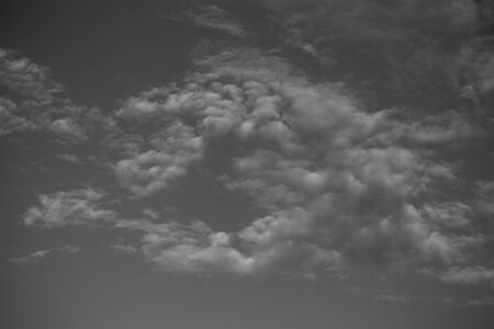Blue sky with white cumulus clouds. Toned.