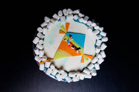 Birthday cake with inscription Happy birthday, Juliana on blue background.