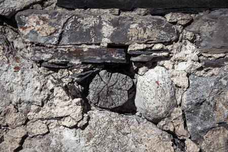 Detail of a wall of an ancient stone house. Toned.