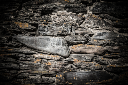 Detail of a wall of an ancient stone house. Toned.の写真素材