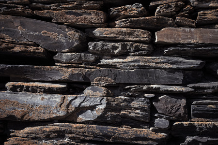 Detail of a wall of an ancient stone house. Toned.の写真素材