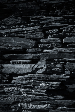 Detail of a wall of an ancient stone house. Toned.