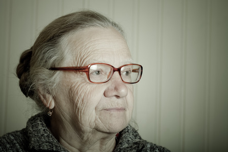 Portrait of elderly woman with glasses. Toned.