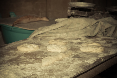The process of baking bread in a traditional Georgian stove - tone (tandoor). Toned.