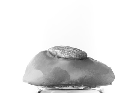 One chocolate candy on a light background. Toned.