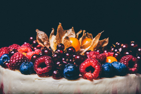 Biscuit homemade cake with cream and berries. Toned.の写真素材