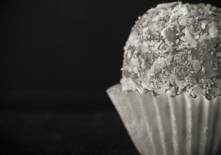 One chocolate candy on a slate background. Toned.の写真素材