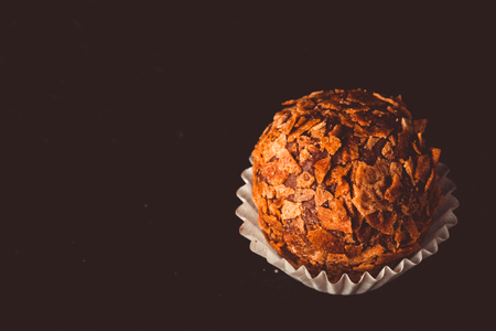 One chocolate candy on a slate background. Toned.の写真素材