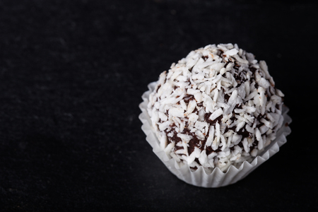 One chocolate candy on a slate background.の写真素材