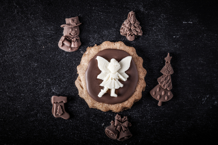 Homemade cookies with chocolate pictures, shortbread and chocolate on a black slate table. Toned.の写真素材