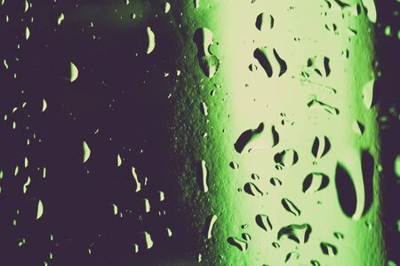 Water droplets on colored ice cubes. Abstract background texture. Very shallow depth of field. Selective focus. Toned.の写真素材