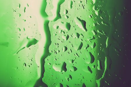 Water droplets on colored ice cubes. Abstract background texture. Very shallow depth of field. Selective focus. Toned.の写真素材