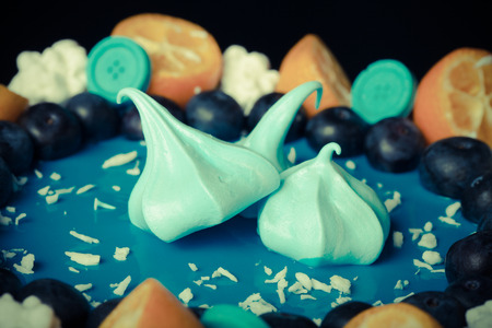 Blue mousse cake with berries, fruit and chocolate. Shallow depth of field. Selective focus. Toned.の写真素材