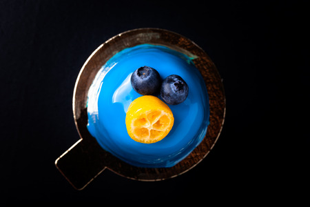 Blue mousse cake with berries, fruit and chocolate.の写真素材