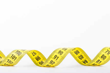 Yellow color centimeter with black figures for measurement of length and width on a white background. Selective focus.の写真素材