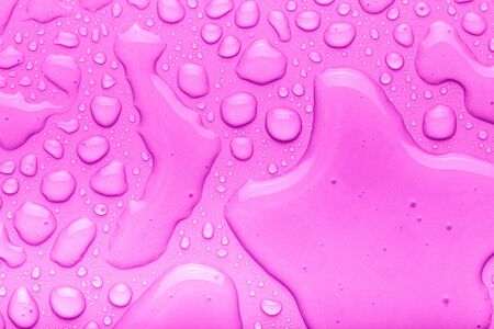 Drops of water on a color background. Pink. Toned.の写真素材