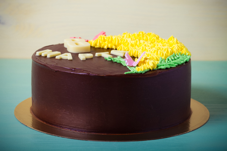 Chocolate cake with inscription "8 march" on light background. Selective focus. Toned.の写真素材