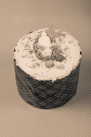 Homemade traditional Easter cake on a wooden background. Toned.