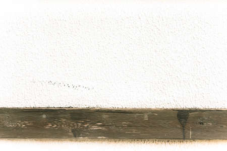 Light plastered wall with wooden stripes for background. Close up detail. Toned.の写真素材