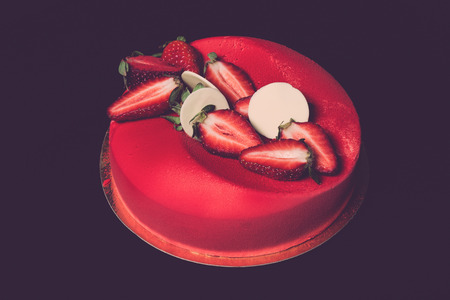 Homemade cake with creamy decor on a black background. Toned.の写真素材