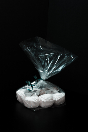 Set of sweets - marshmallows and chocolates in a festive cellophane package. Toned.の写真素材