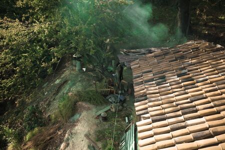 Tile roof of old house on background of beautiful autumn mountain landscape in Kakheti. Georgia. Toned.の写真素材