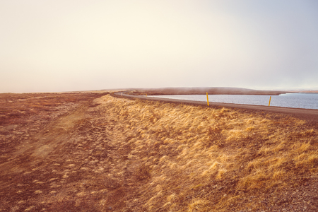 Gravel road on the shore of the fjord in the east of Iceland. Toned.の写真素材