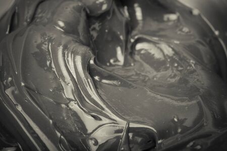 Texture of smears of soft chocolate for a background. Selective focus. Toned.