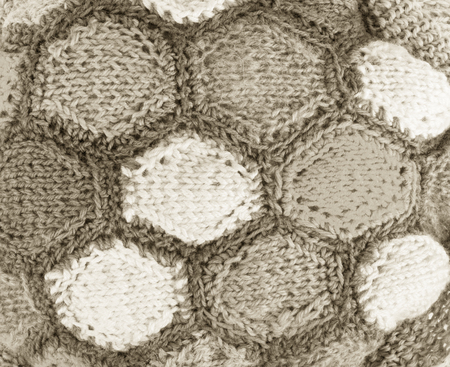 Knitted pattern from woolen warm soft yarn for background.