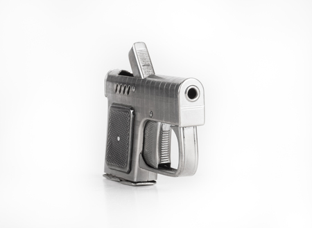 Lighter in the form of a gun on a light background.の写真素材